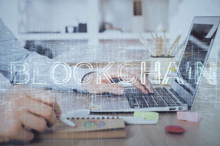 Blockchain theme hud with man working on computer on background. Concept of crypto chain. Double exposure.の写真素材