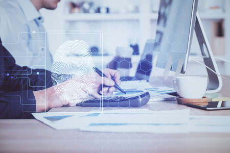 Fingerprint hologram with businessman working on computer on background. Security concept. Double exposure.の写真素材
