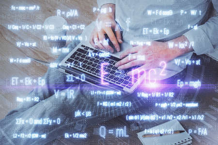 Science formula hologram with man working on computer on background. Education concept. Double...