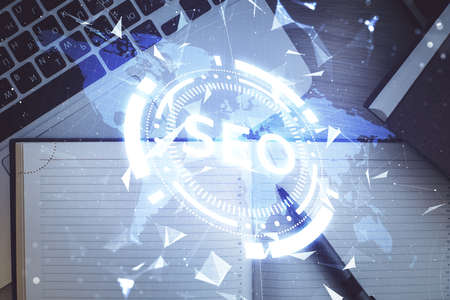 Double exposure of SEO drawing over study table background with computer. Concept of search. Top...