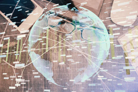 Double exposure of business theme hologram over desktop with phone. Top view. Mobile international...