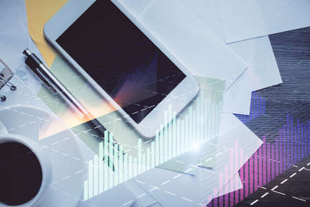 Multi exposure of forex graph hologram over desktop with phone. Top view. Mobile trade platform...