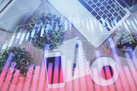 Multi exposure of financial chart hologram over desktop with phone. Top view. Mobile trade platform concept.の写真素材