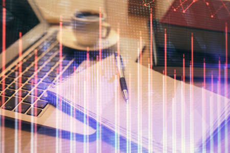 Double exposure of forex chart drawing and desktop with coffee and items on table background....