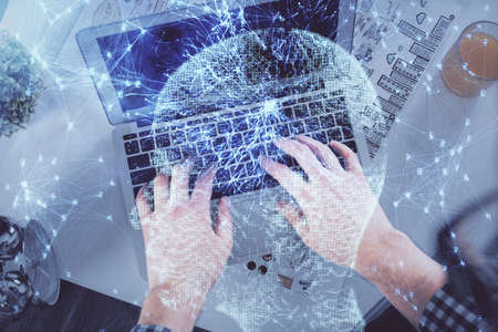Double exposure of mans hands typing over computer keyboard and brain hologram drawing. Top view. Ai...