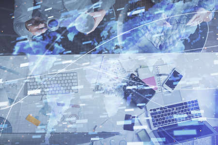 Double exposure of man and woman working together and data theme hologram drawing. Computer background. Top View.の写真素材