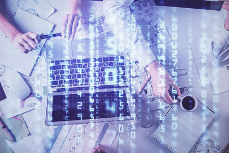 Double exposure of man and woman working together and technology theme drawing hologram. Big data...