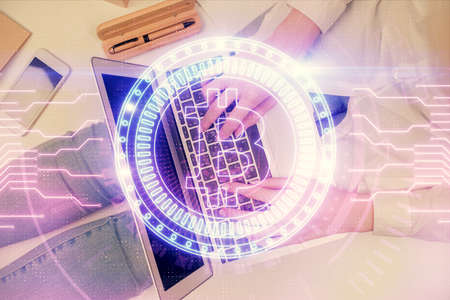 Double exposure of woman hands working on computer and blockchain theme hologram drawing. Top View....
