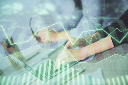 Multi exposure of woman hands typing on computer and financial chart hologram drawing. Stock market...