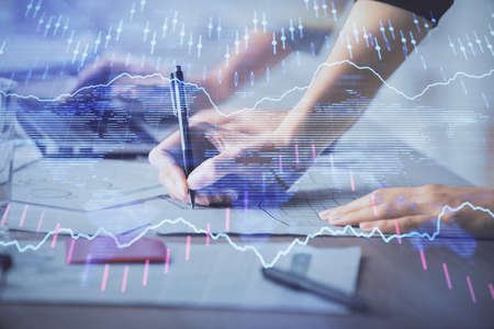 Multi exposure of woman hands typing on computer and financial chart hologram drawing. Stock market analysis concept.の写真素材