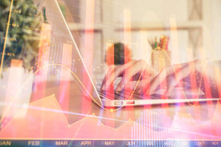 Double exposure of woman hands typing on computer and forex chart hologram drawing. Stock market invest concept.の写真素材