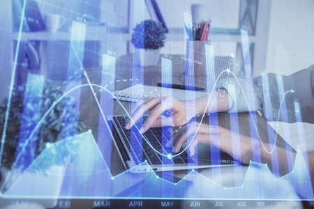 Double exposure of woman hands typing on computer and forex chart hologram drawing. Stock market...