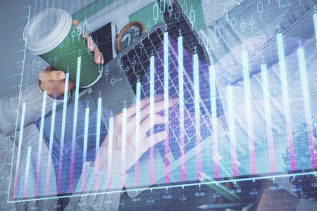 Double exposure of woman hands typing on computer and forex chart hologram drawing. Stock market...