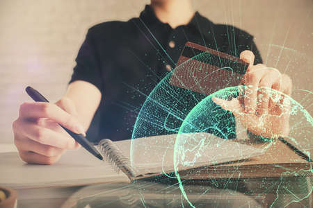 Double exposure of man hands holding a credit card and social network theme drawing. Digital finance...