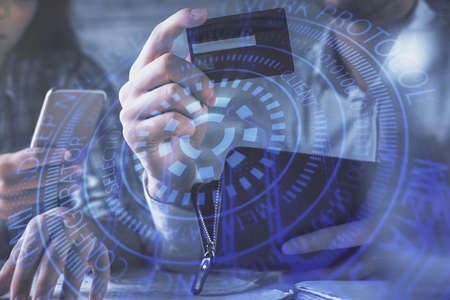 Double exposure of man and woman on-line shopping holding a credit card and data theme hologram drawing. Ai and E-commerce pay on-line concept.の写真素材