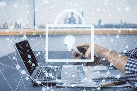 Multi exposure of mans hands holding and using a digital device and lock drawing. Security concept.