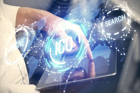 Double exposure of mans hands holding and using a phone and crypto currency blockchain theme...