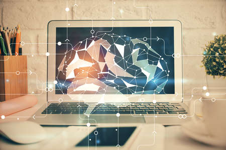 Double exposure of work space with computer and human brain drawing hologram. Brainstorm concept.