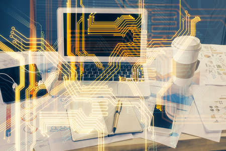 Computer on desktop in office with technology theme hologram. Multi exposure. Tech concept.