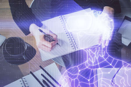 AR hologram over womans hands taking notes background. Concept of augmented reality. Multi exposure