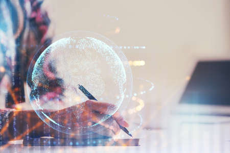 Multi exposure of hands making notes with world map hologram and data theme icons. Concept of global computer data.の写真素材