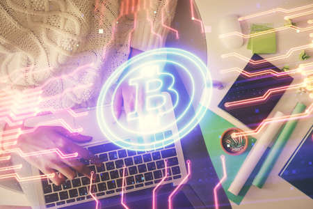Double exposure of woman hands working on computer and blockchain theme hologram drawing. Top View....