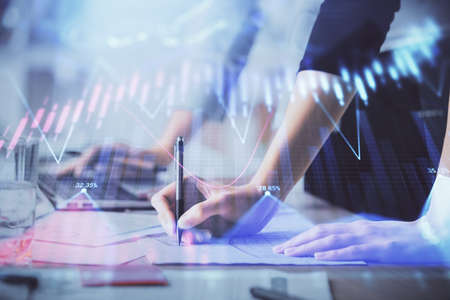 Multi exposure of woman hands typing on computer and financial chart hologram drawing. Stock market...