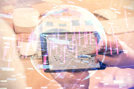 Double exposure of mans hands holding and using a phone and financial chart drawing. Market analysis...
