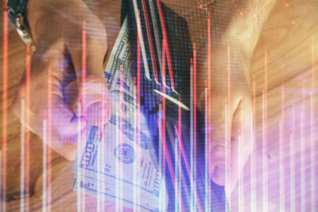 Multi exposure of forex graph drawing hologram and USA dollars bills and man hands. Technical...