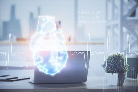 Desktop computer background and heart drawing. Double exposure. Medical study and healthcare concept.の写真素材