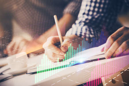 Multi exposure of two men planing investment with stock market forex chart background. Concept of research and trading.の写真素材