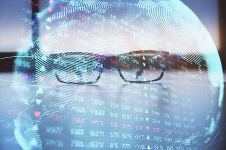 Business theme hologram with glasses on the table background. Concept of search. Double exposure.の写真素材