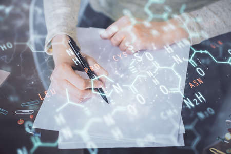 Science formula hologram over womans hands taking notes background. Concept of study. Multi exposure