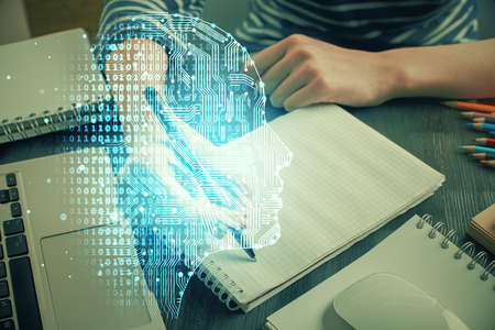 Multi exposure of writing hand on background with brain hologram. Concept of self learning.