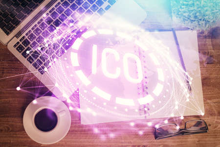 Block chain theme hologram drawings over computer on the desktop background. Top view. Double...