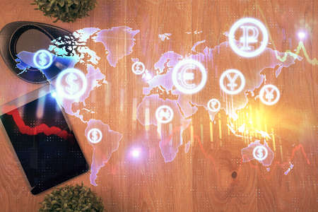 Multi exposure of financial chart hologram over desktop with phone. Top view. Mobile trade platform...