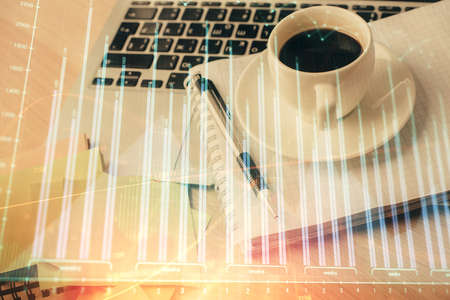 Double exposure of forex chart drawing and desktop with coffee and items on table background. Concept of financial market tradingの写真素材