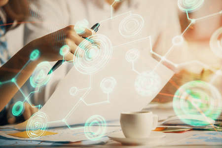 Double exposure of social network theme drawing over people taking notes background. Concept of...