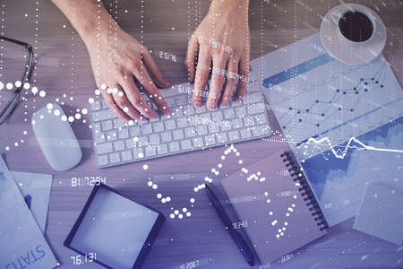 Double exposure of mans hands typing over computer keyboard and data theme hologram drawing. Top...
