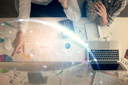 Double exposure of man and woman working together and social network theme hologram drawing....