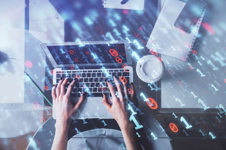 Double exposure of woman hands working on computer and data theme hologram drawing. Top View....