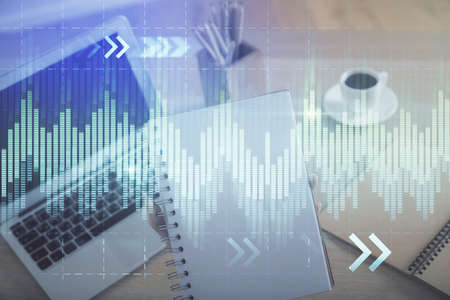 Double exposure of businesswoman hands typing on computer and forex chart hologram drawing....
