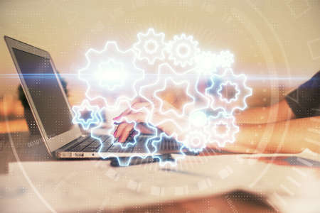 Multi exposure of woman hands typing on computer and business theme hologram drawing. Success...