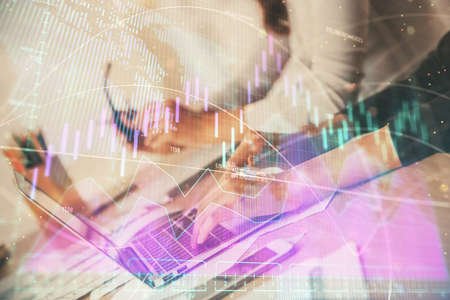 Multi exposure of woman hands typing on computer and financial chart hologram drawing. Stock market...