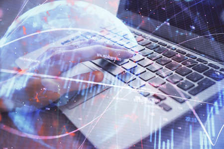 Double exposure of woman hands typing on computer and forex chart hologram drawing. Stock market...