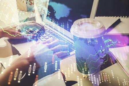 Double exposure of woman hands typing on computer and forex chart hologram drawing. Stock market...