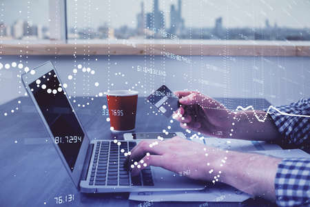 Double exposure of man hands holding a credit card and data theme drawing. E-commerce and technology...
