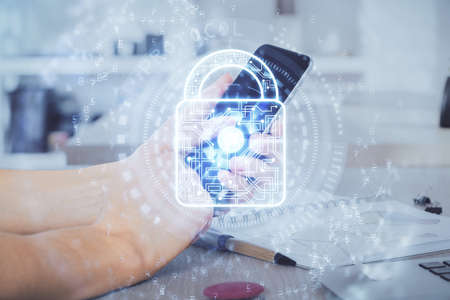 Multi exposure of mans hands holding and using a digital device and lock drawing. Security concept.の写真素材