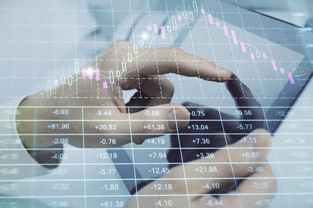 Multi exposure of mans hands holding and using a phone and financial chart drawing. Market analysis...