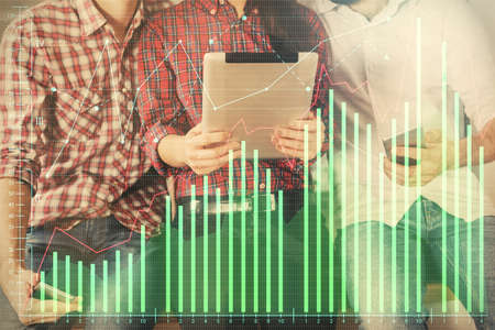 Double exposure of forex graph drawing and man and woman working together holding and using a mobile device. Trade concept.の写真素材